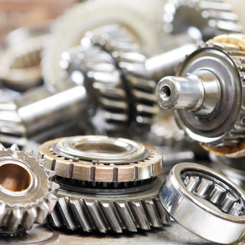 Close-up of automobile engine steel gears and bearings disassembled for repair at car service station