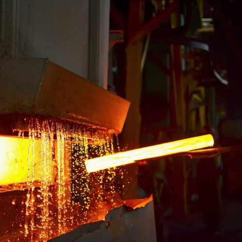 Steel quenching at high temperature in industrial furnace at the workshop of a forge plant. Process of cooling, heat treatmen. Blacksmith and metallurgical industry, hot rolling mill. Small sharpness